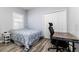 This bedroom features wood floors, a closet, a window and a desk setup at 6148 Gracie Pl, Lakeland, FL 33812
