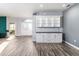 Inviting entryway featuring a custom cabinet with glass doors and a view into another room at 6148 Gracie Pl, Lakeland, FL 33812