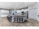 Spacious eat-in kitchen features a large island with stone countertops, stainless steel appliances, and ample white cabinetry at 6148 Gracie Pl, Lakeland, FL 33812