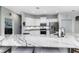 Close-up of the kitchen island shows a stainless steel sink, stone countertop, and stainless steel appliances at 6148 Gracie Pl, Lakeland, FL 33812