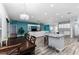 Open concept living and dining area boasts wood-look floors, modern lighting, and a large island with seating at 6148 Gracie Pl, Lakeland, FL 33812