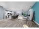 Open concept living room with a modern kitchen, dining area and sliding glass doors to the pool at 6148 Gracie Pl, Lakeland, FL 33812