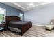 Spacious main bedroom featuring a large bed, tray ceiling, and ample natural light from windows at 6148 Gracie Pl, Lakeland, FL 33812