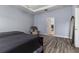 Serene main bedroom with a tray ceiling, seating area, and view into the walk-in closet at 6148 Gracie Pl, Lakeland, FL 33812