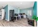 A spacious home office featuring multiple computer setups, a decorative screen, and modern flooring at 6148 Gracie Pl, Lakeland, FL 33812