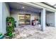 Covered patio with an outdoor cooking area, string lights, and access to the pool and backyard at 6148 Gracie Pl, Lakeland, FL 33812