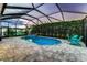 Screened pool featuring a hot tub, tiled surround, an outdoor kitchen, and an expansive deck for entertaining at 6148 Gracie Pl, Lakeland, FL 33812