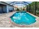 Screened pool featuring a hot tub, tiled surround, and an outdoor living space for relaxation and entertainment at 6148 Gracie Pl, Lakeland, FL 33812