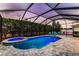 Screened pool and spa with lush landscaping offer a private outdoor oasis at 6148 Gracie Pl, Lakeland, FL 33812