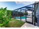 Screened pool with lush landscaping, a spa, and a spacious patio perfect for enjoying outdoor living at 6148 Gracie Pl, Lakeland, FL 33812
