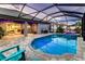 Relaxing screened-in pool area with inviting blue pool and spa, set up with chairs for lounging at 6148 Gracie Pl, Lakeland, FL 33812