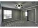 Neutral bedroom featuring plush gray carpet, ceiling fan, closet with sliding mirrored doors and natural light at 634 Steamboat Ct # 171, Altamonte Springs, FL 32714