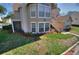 Exterior view of charming two-story tan home with green lawn and mulch beds in a residential neighborhood at 634 Steamboat Ct # 171, Altamonte Springs, FL 32714
