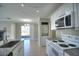 Bright and modern kitchen featuring granite countertops, white appliances, and a functional layout for cooking at 634 Steamboat Ct # 171, Altamonte Springs, FL 32714
