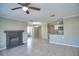 Open-concept living room with tile flooring, a fireplace, and a seamless transition to the kitchen area at 634 Steamboat Ct # 171, Altamonte Springs, FL 32714