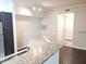 Kitchenette features a granite countertop, stainless steel sink, and dark wood floors at 6412 Queens Borough Ave # 109, Orlando, FL 32835