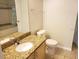 Bathroom with a large mirror over a granite sink, toilet, and tub/shower combination at 6412 Queens Borough Ave # 109, Orlando, FL 32835