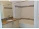Clean bathroom featuring a shower and tub combination, granite counters, and tile floors at 6412 Queens Borough Ave # 109, Orlando, FL 32835