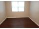 Bright bedroom with hardwood floors and a large window letting in plenty of natural light at 6412 Queens Borough Ave # 109, Orlando, FL 32835