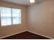 This bedroom has dark wood floors, a ceiling fan, and large window that brings in natural light at 6412 Queens Borough Ave # 109, Orlando, FL 32835