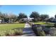 Community view showing the manicured green spaces, sidewalks, and gazebo at 6412 Queens Borough Ave # 109, Orlando, FL 32835