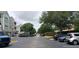Wide view of the community street and condo buildings, showing the ample parking at 6412 Queens Borough Ave # 109, Orlando, FL 32835