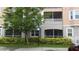 Close-up exterior view of condo building showcasing screened patios, landscaping, and accessible parking at 6412 Queens Borough Ave # 109, Orlando, FL 32835