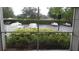 Patio view showcasing landscaping, a parking lot and other community buildings beyond at 6412 Queens Borough Ave # 109, Orlando, FL 32835