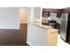 Modern kitchen with stainless steel appliances, granite countertops and dark wood cabinets at 6412 Queens Borough Ave # 109, Orlando, FL 32835