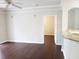 Living room view featuring dark wood floors and granite breakfast bar to the kitchen at 6412 Queens Borough Ave # 109, Orlando, FL 32835