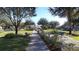 Scenic community park featuring walking path, benches, lush landscaping and gazebo at 6412 Queens Borough Ave # 109, Orlando, FL 32835