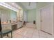 Spacious bathroom features dual vanities, large mirrors, and soaking tub at 6850 Huntington Hills Blvd, Lakeland, FL 33810