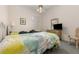 Inviting bedroom with bright bedding, a ceiling fan, and a large window for a light and airy feel at 6850 Huntington Hills Blvd, Lakeland, FL 33810