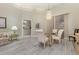 A dining area featuring bright lighting, wood-look flooring, and seating for four at 6850 Huntington Hills Blvd, Lakeland, FL 33810