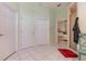 Hallway leading to bedroom with tiled floor and multiple closets and storage at 6850 Huntington Hills Blvd, Lakeland, FL 33810