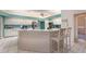 Bright and open kitchen with updated appliances, white tile floors and ample counter space at 6850 Huntington Hills Blvd, Lakeland, FL 33810