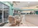 Bright kitchen with turquoise walls, stainless steel appliances, and a glass-topped dining set at 6850 Huntington Hills Blvd, Lakeland, FL 33810
