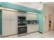 Well-lit kitchen with white cabinetry, stainless steel appliances, and blue backsplash at 6850 Huntington Hills Blvd, Lakeland, FL 33810