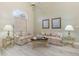 Cozy living room featuring neutral paint, wood-look floors, and comfortable seating at 6850 Huntington Hills Blvd, Lakeland, FL 33810