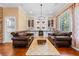 Inviting living room featuring a full bar with wine rack, mini-fridge, and comfortable leather couches at 740 Hillcrest Ln, Altamonte Springs, FL 32701