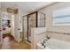 Bathroom features a glass-enclosed shower, soaking tub, and tile flooring with mosaic accents at 8125 Atlantic Puffin St, Winter Garden, FL 34787