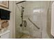 Tiled walk-in shower with glass door, rainfall shower head, and safety bar at 8125 Atlantic Puffin St, Winter Garden, FL 34787