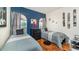 Comfortable bedroom featuring two beds, hardwood floors, themed decor, and bright windows at 8157 Fan Palm Way, Kissimmee, FL 34747