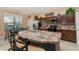Spacious kitchen with dark cabinets, stainless steel appliances, and a large center island with seating at 8157 Fan Palm Way, Kissimmee, FL 34747