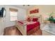 Well-appointed main bedroom with a large bed, wood floors, bedside tables, and a TV at 8157 Fan Palm Way, Kissimmee, FL 34747