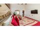 Elegant main bedroom with a king-size bed, vaulted ceiling, TV, and access to a private bathroom at 8157 Fan Palm Way, Kissimmee, FL 34747