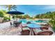 Resort-style pool with comfortable seating and shaded umbrellas, ideal for relaxation and socializing at 8157 Fan Palm Way, Kissimmee, FL 34747