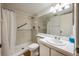 Bathroom featuring a shower, grab bars, and a vanity with ample counter space and storage at 8215 Sun Spring Cir # 32, Orlando, FL 32825