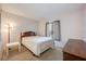 Bright bedroom featuring a wooden headboard, bedside table and natural light from the window at 8215 Sun Spring Cir # 32, Orlando, FL 32825