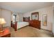 Bedroom with a decorative wooden bed frame, dresser, and natural light from the window at 8215 Sun Spring Cir # 32, Orlando, FL 32825